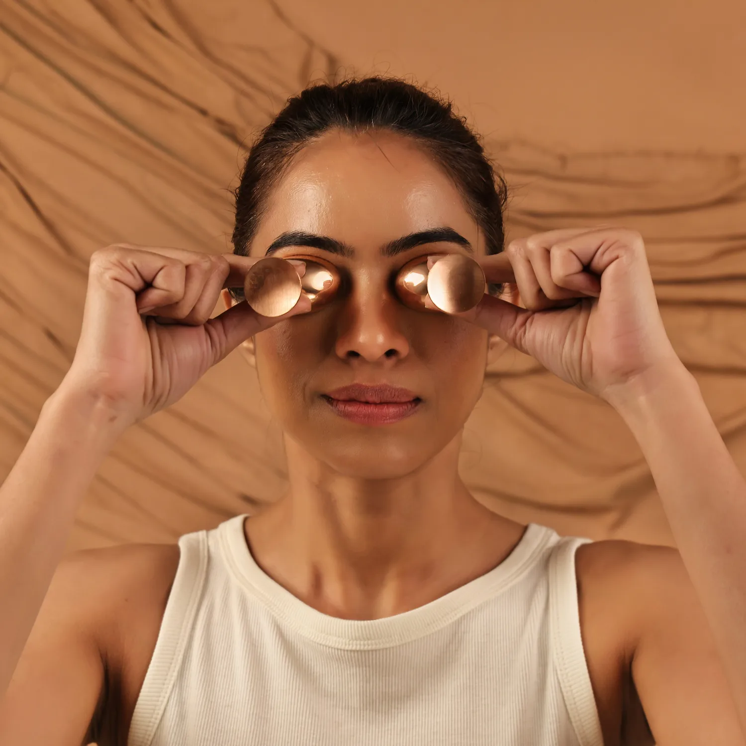 Art of Vedas Ayurvedic eye care: a copper eye-wash cup and Ruby Eye Cream arranged for a daily Netra routine