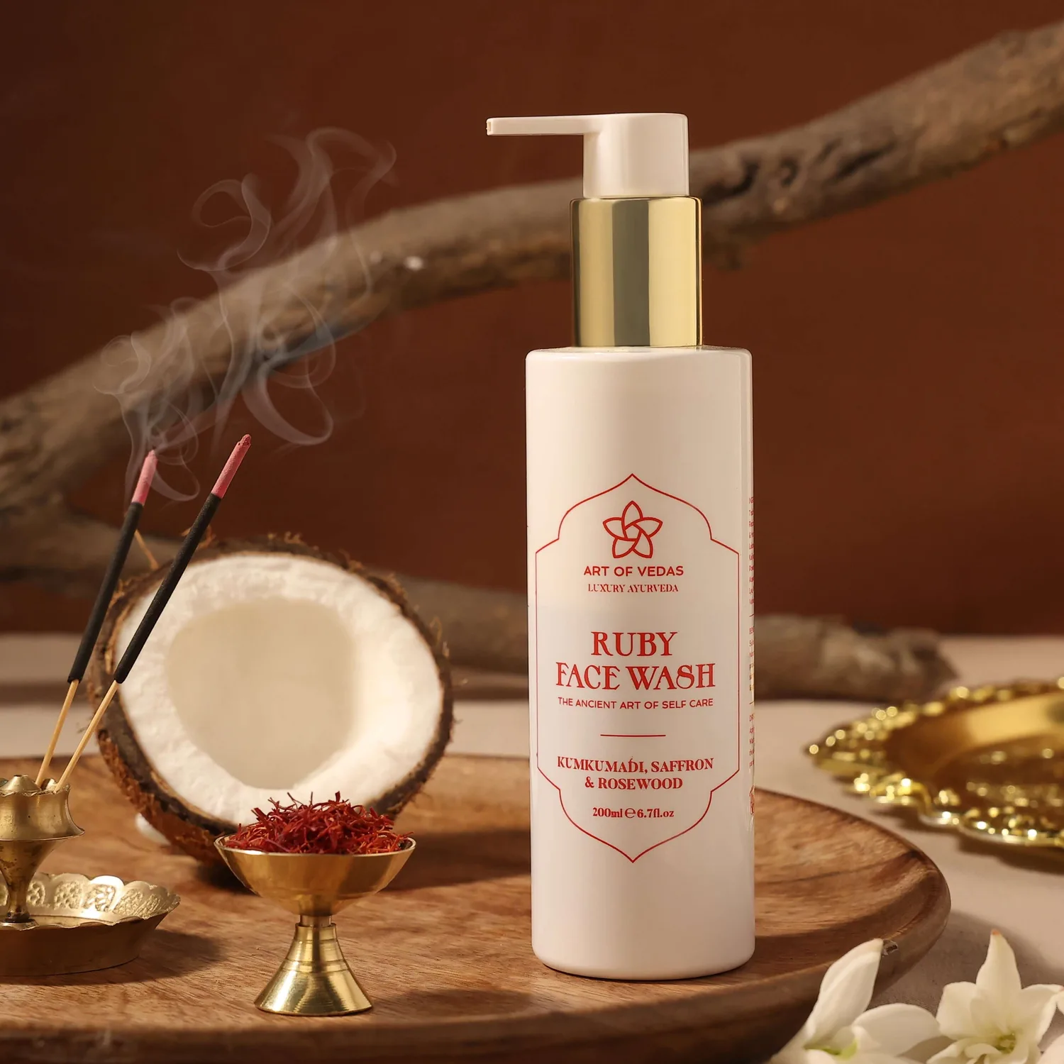 A high-resolution image displaying Art of Vedas Ruby Face Wash. The product is housed in an elegant, amber-colored bottle with a pump dispen